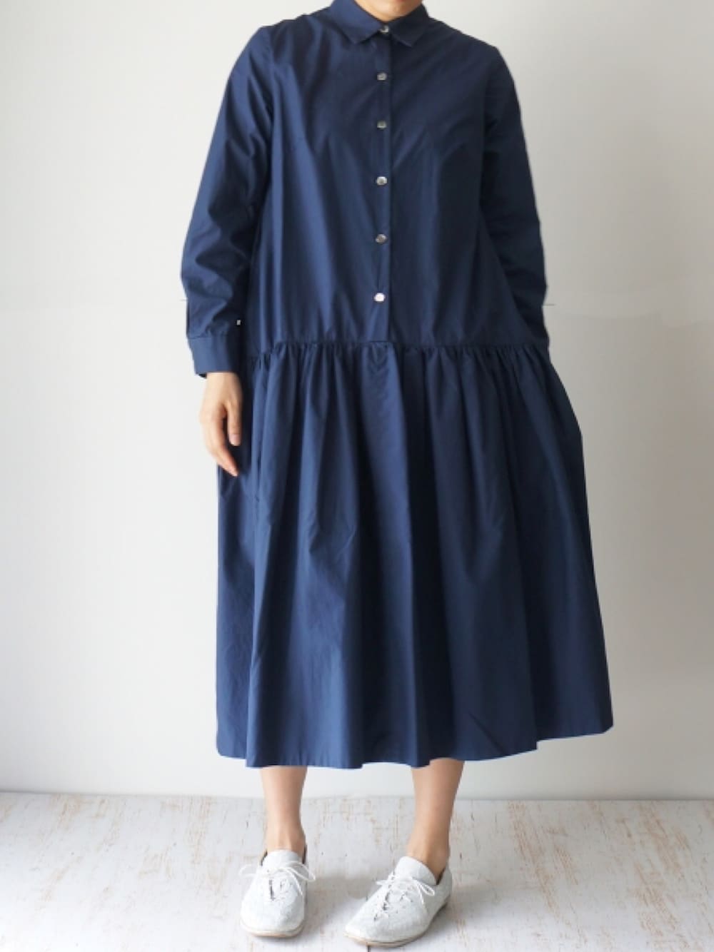 ブルー系のワンピース、ホワイト系のドレスシューズを着用したレディースの秋コーディネートの1枚目の写真