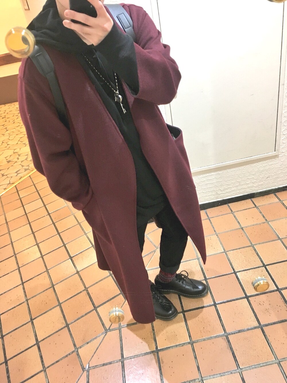 グレー系のその他アウター、ブラック系のパーカー、ブラック系のパンツを着用したメンズの冬コーディネートの1枚目の写真