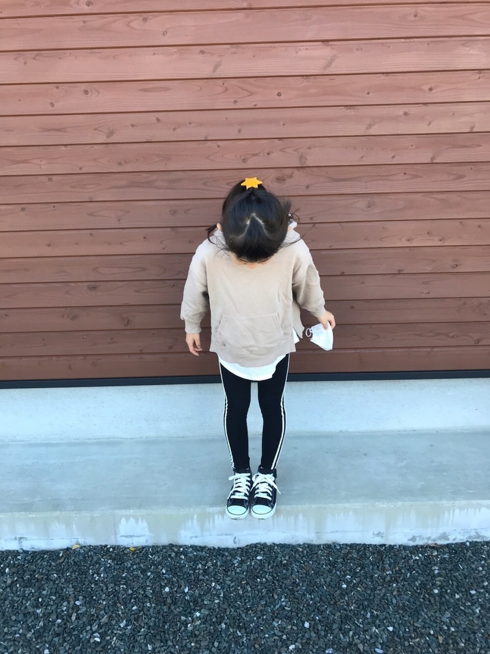ベージュ系のパーカー、ブラック系のスニーカー、ブラック系のレギンス/スパッツを着用したキッズの秋コーディネートの1枚目の写真