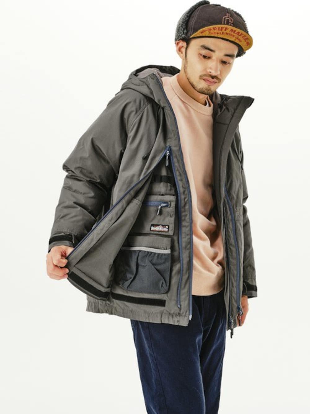 グレー系のマウンテンパーカー、ピンク系のスウェット、ブルー系のその他パンツを着用したメンズの冬コーディネートの1枚目の写真