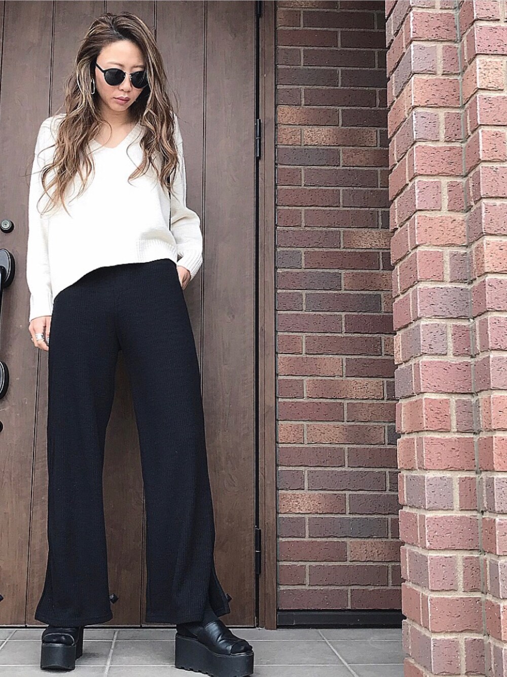 ブラック系のサンダルを着用したレディースの夏コーディネートの1枚目の写真