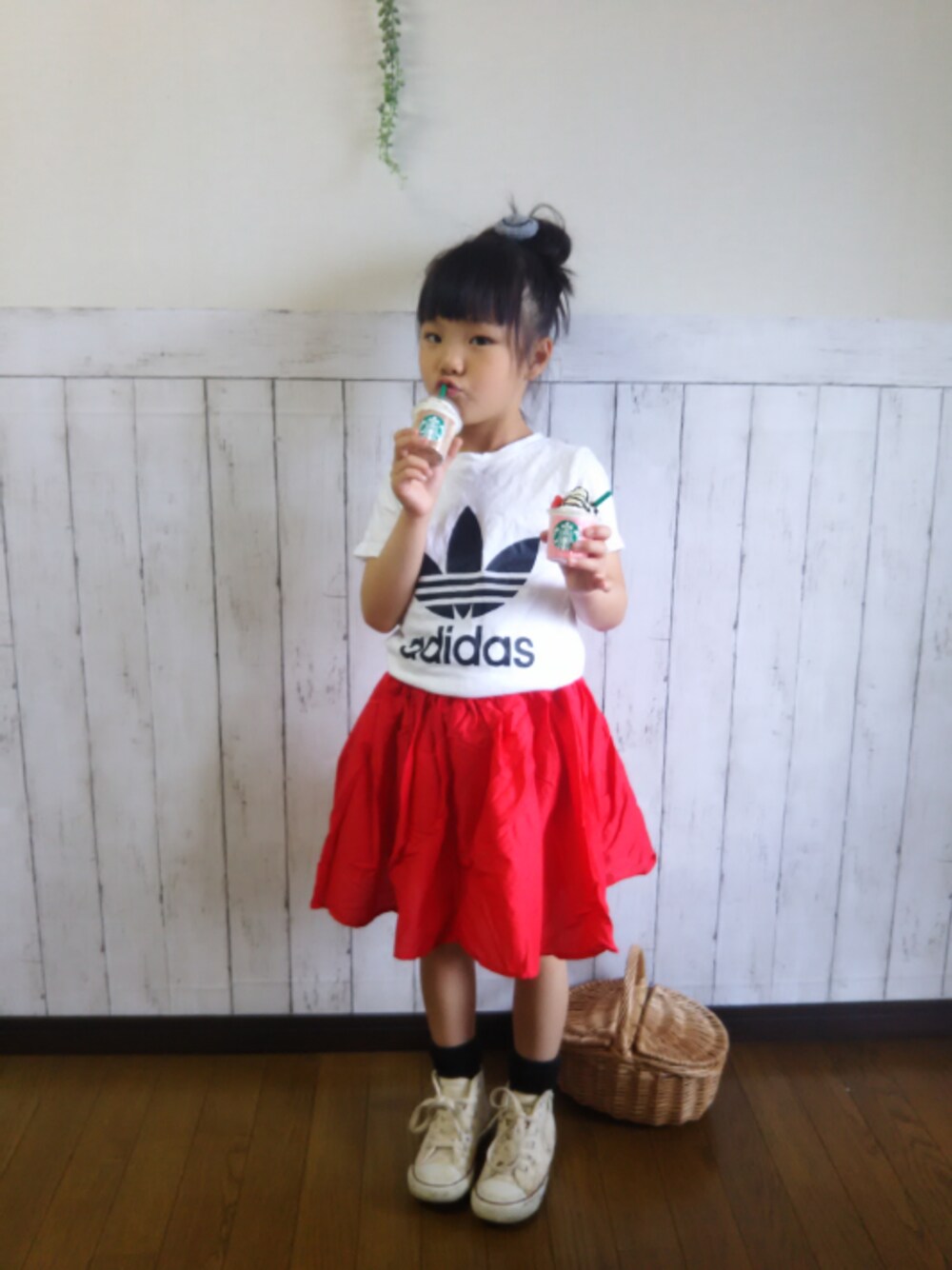 ホワイト系のTシャツ/カットソー、レッド系のスカート、ホワイト系のスニーカーを着用したキッズの春コーディネートの1枚目の写真