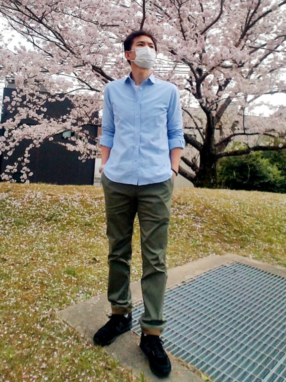 ブルー系のシャツ/ブラウス、ブラック系のスニーカー、グリーン系のカーゴパンツを着用したメンズの春コーディネートの1枚目の写真