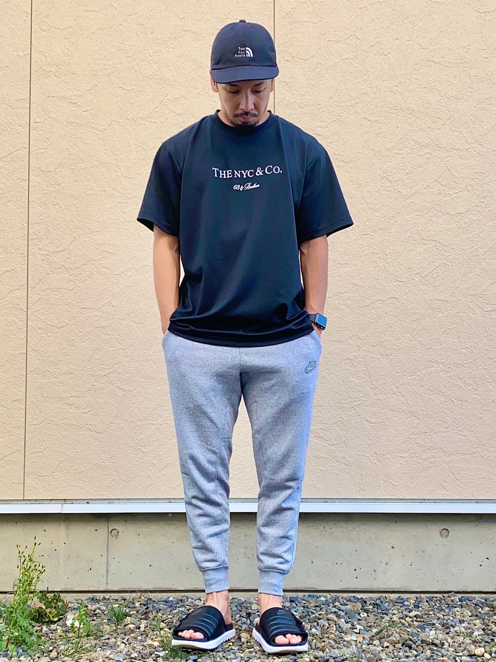 「68&brothers、Tシャツ、スウェットパンツ、NIKE、サンダル、キャップ、700fillpower、Apple Watch、楽チンコーデ」｜「68&brothersのS/S Lite Dry Tee "THENYC&Co."（Tシャツ/カットソー、ブラック系）」を使った、N i s s yさん（メンズ・172cm）の秋コーディネートの1枚目の写真