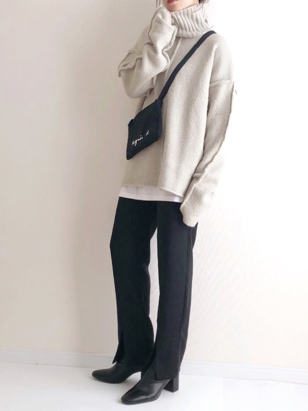 グレー系のニット/セーター、ブラック系のショルダーバッグ、ブラック系のその他パンツを着用したレディースの冬コーディネートの1枚目の写真